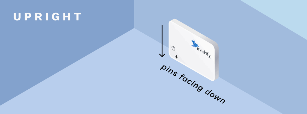 An illustration of the Defender Slim sensor being placed upright against the wall with the sensor's pins facing down to the ground.